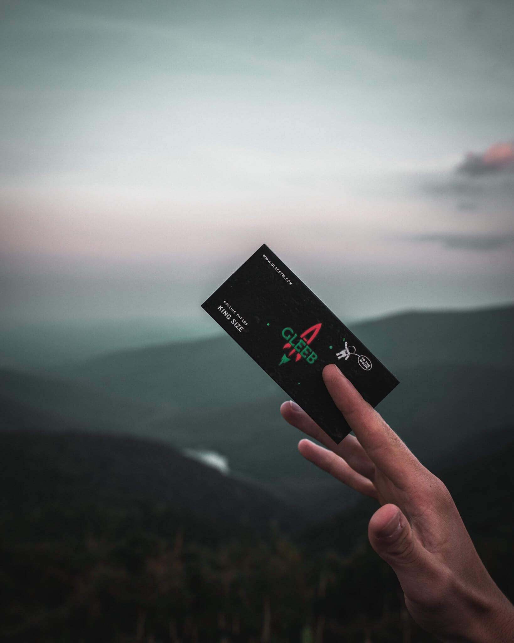 person holding Gleeb hemp rolling paper package
